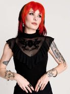 a black sheer mock-neck top with a black graphic on the chest