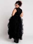 a black sheer mock-neck top with a black graphic on the chest