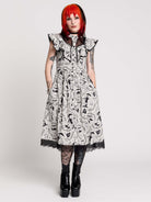 black and white gothic-style dress with a bird pattern, lace trim, and a high ruffled collar