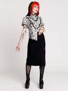  a black and white patterned ruffled blouse
