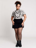  a black and white patterned ruffled blouse