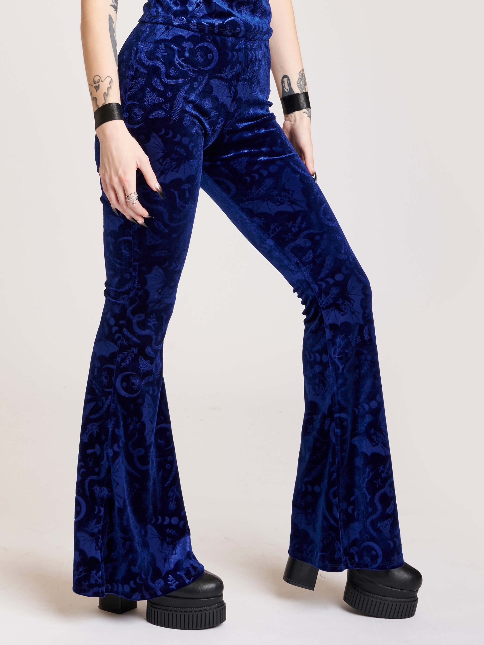 embossed velvet flaired pants with forest findings symbols
