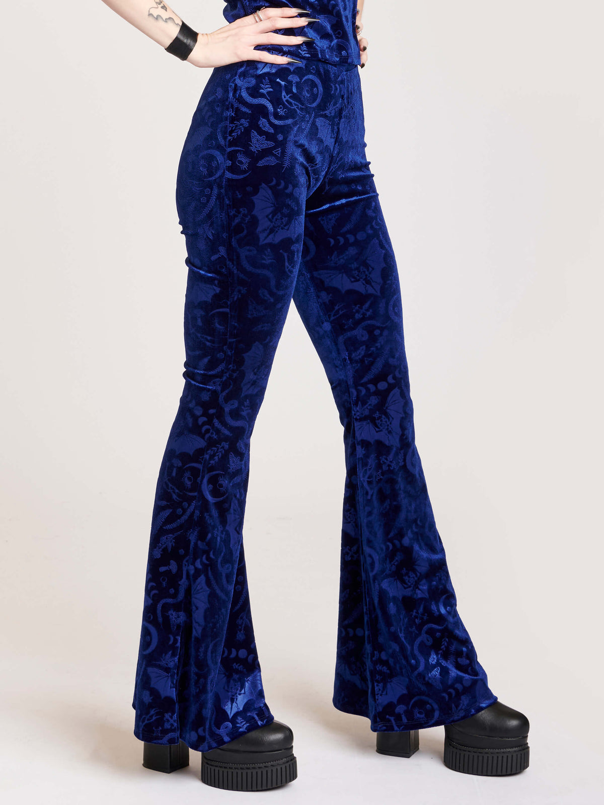 embossed velvet flaired pants with forest findings symbols