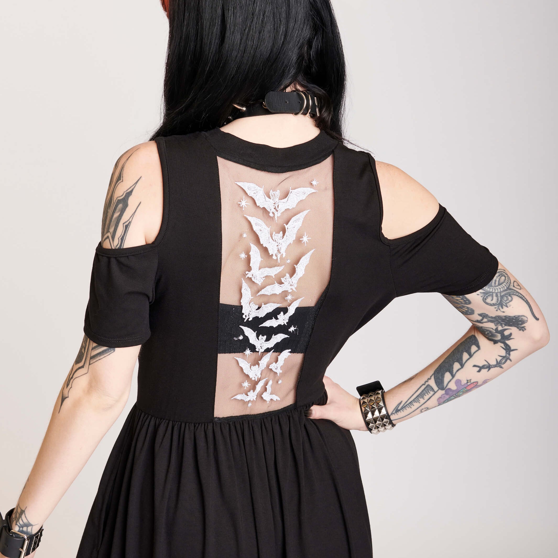 cold shoulder dress with bat embroidered mesh back panel.