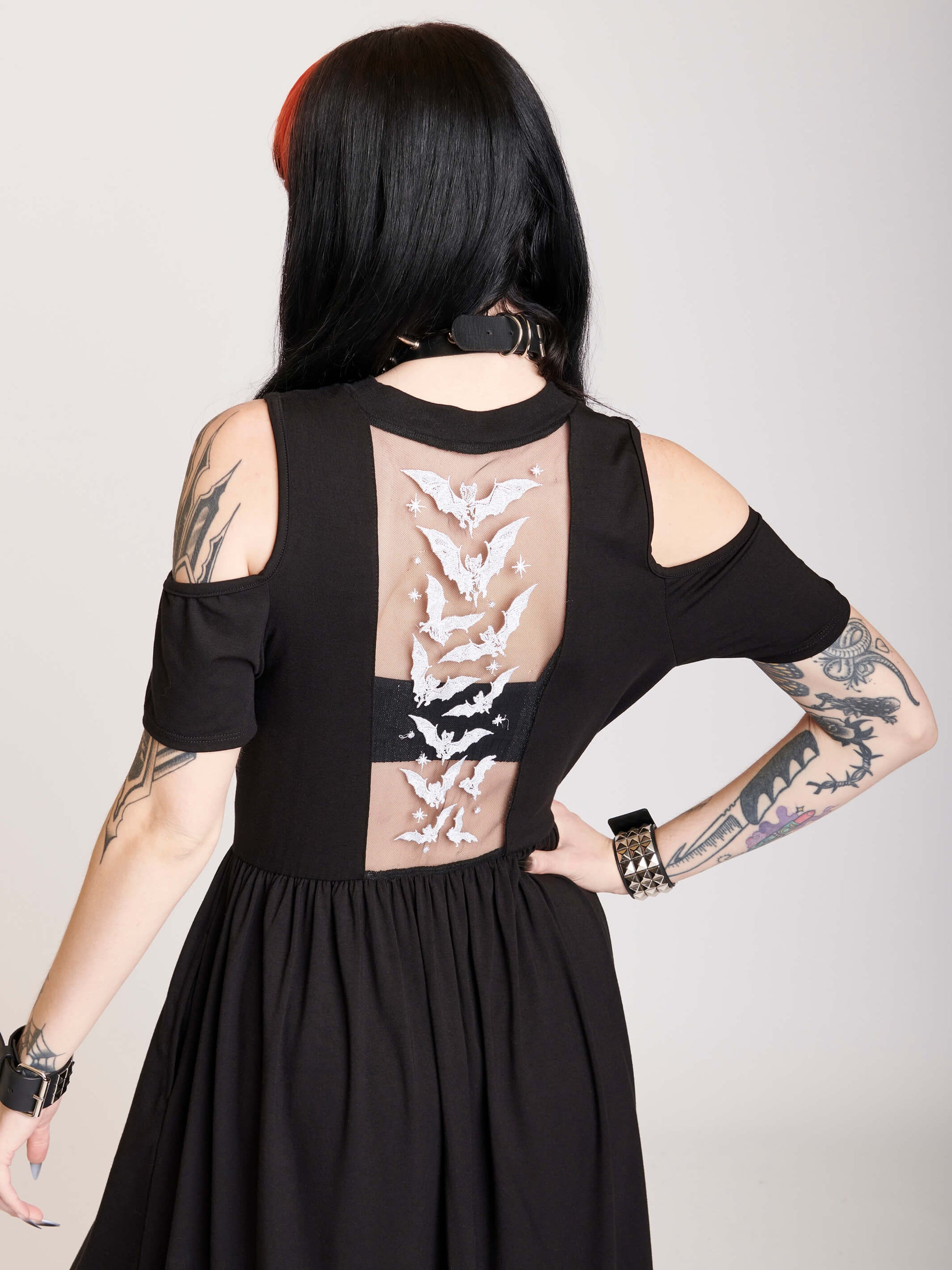 cold shoulder dress with bat embroidered mesh back panel.