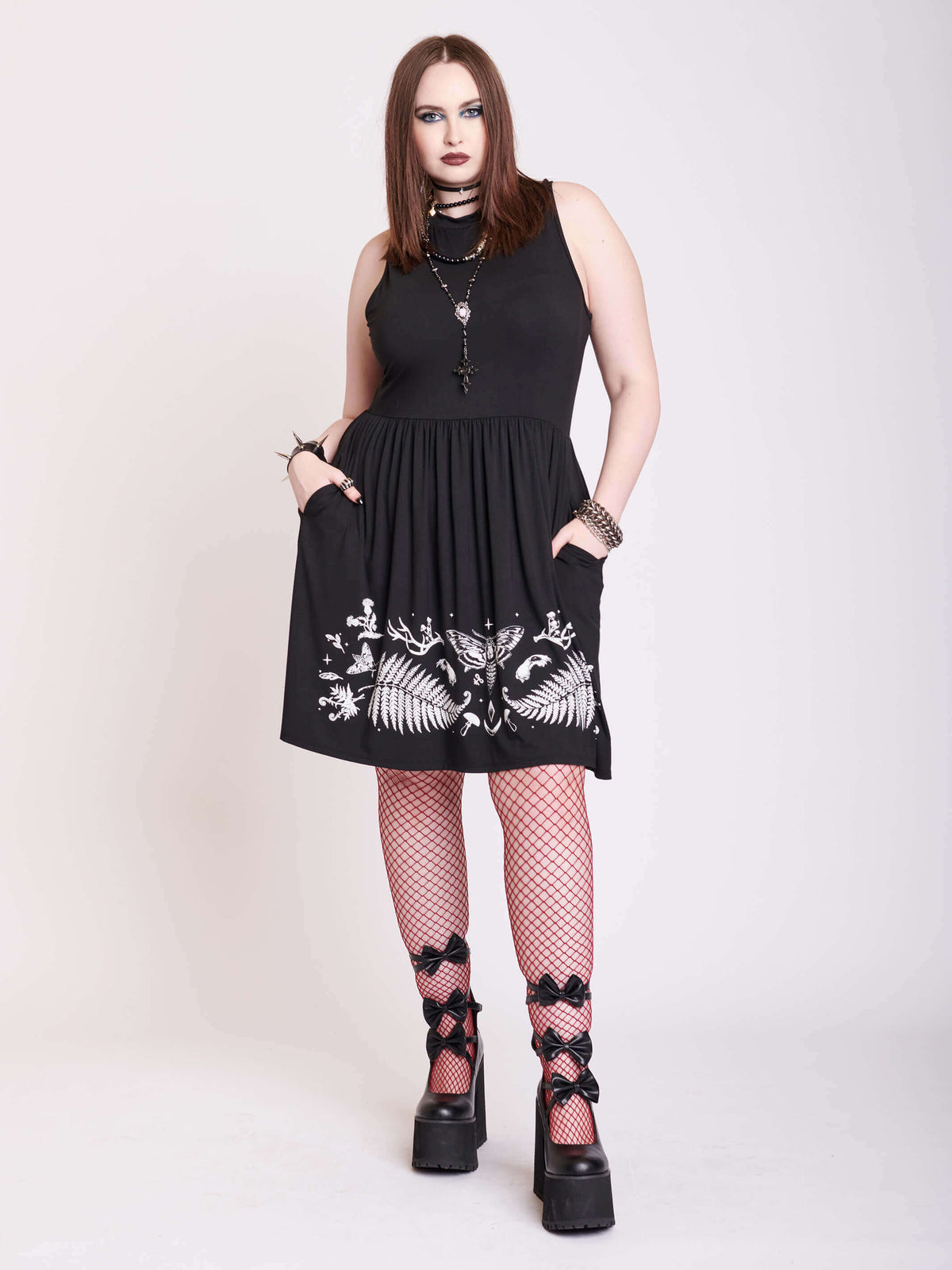 black sleevless dress with forest findings graphics on skirt
