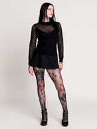Fishnet Sweetheart Rib Sweater, a black long-sleeve top with a fitted rib-knit body and fishnet across the upper chest, shoulders, upper back and sleeves, giving a  “sweetheart” illusion while keeping the sleek silhouette sleek.