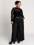 Fishnet Sweetheart Rib Sweater, a black long-sleeve top with a fitted rib-knit body and fishnet across the upper chest, shoulders, upper back and sleeves, giving a  “sweetheart” illusion while keeping the sleek silhouette sleek.