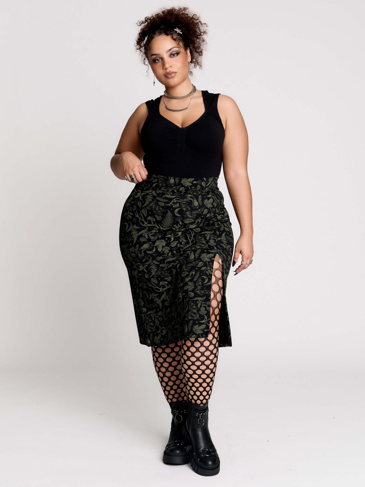 a black midi skirt with a green forest findings print. 