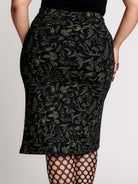 a black midi skirt with a green forest findings print. 