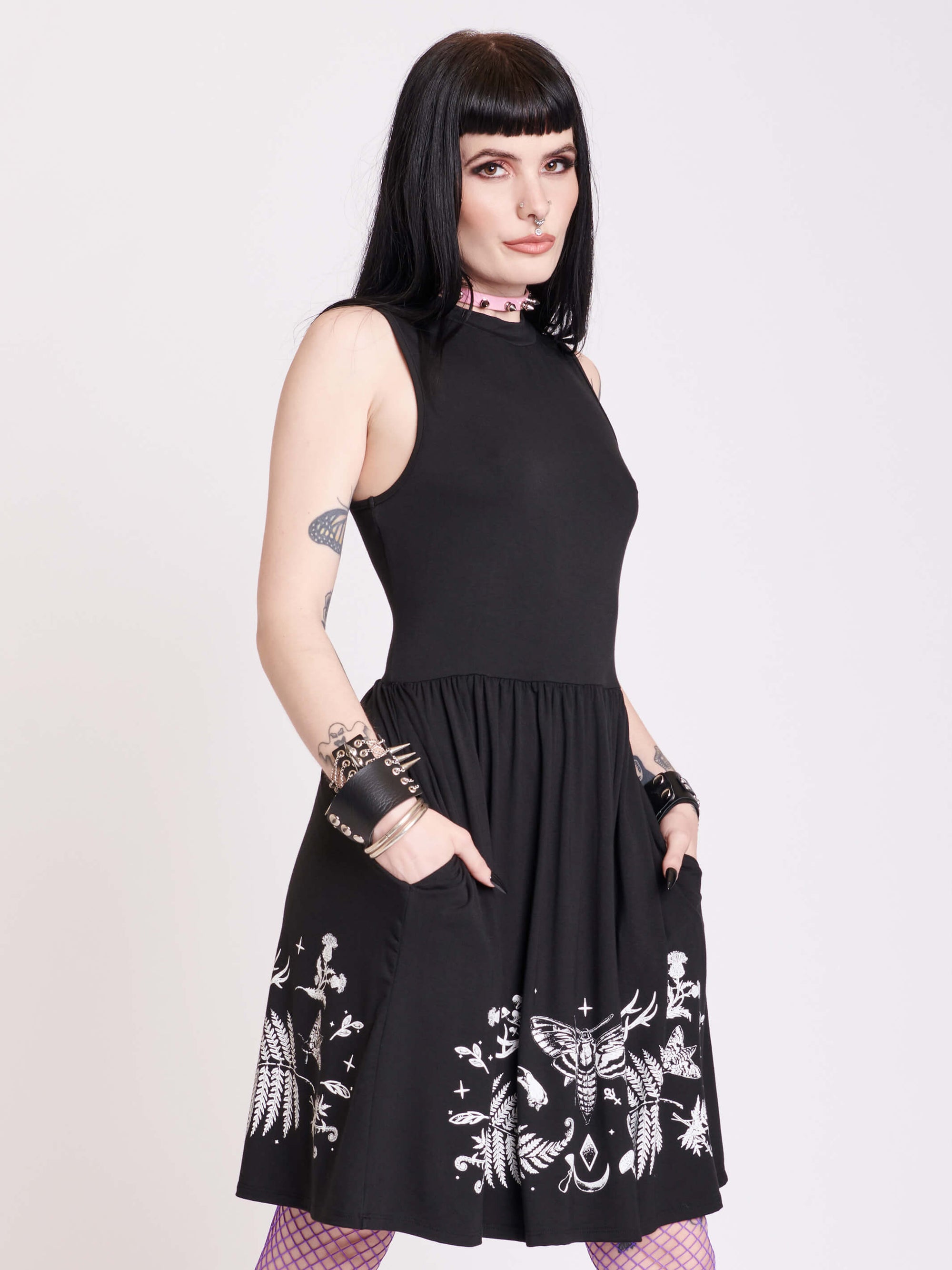 black sleevless dress with forest findings graphics on skirt