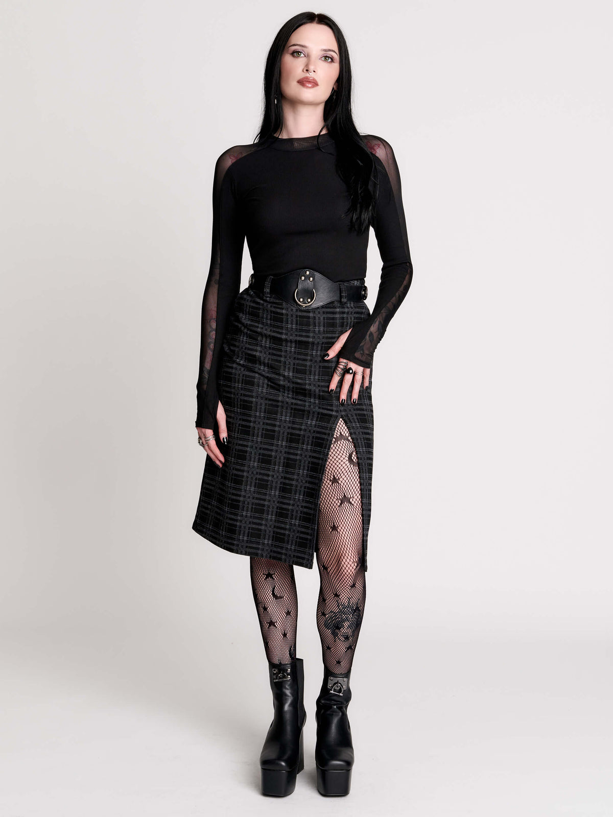  a black and gray plaid midi skirt with a front slit, 