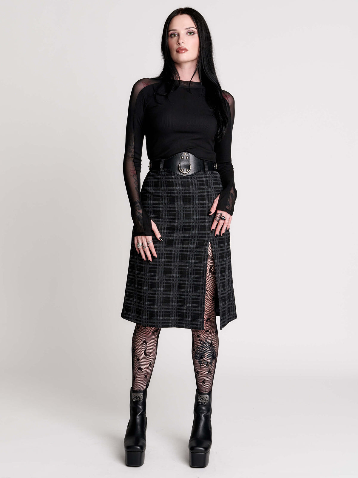  a black and gray plaid midi skirt with a front slit, 