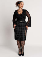  a black and gray plaid midi skirt with a front slit, 