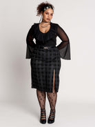  a black and gray plaid midi skirt with a front slit, 