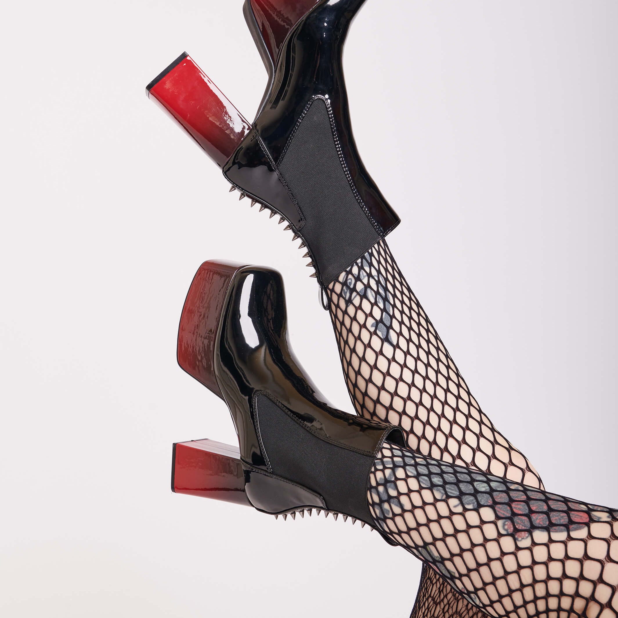 ombre red and black vegan patent leather platform boots with spikes down the back