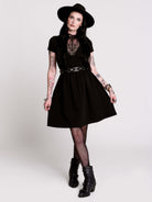 A black short-sleeve dress with a lace V-neckline.