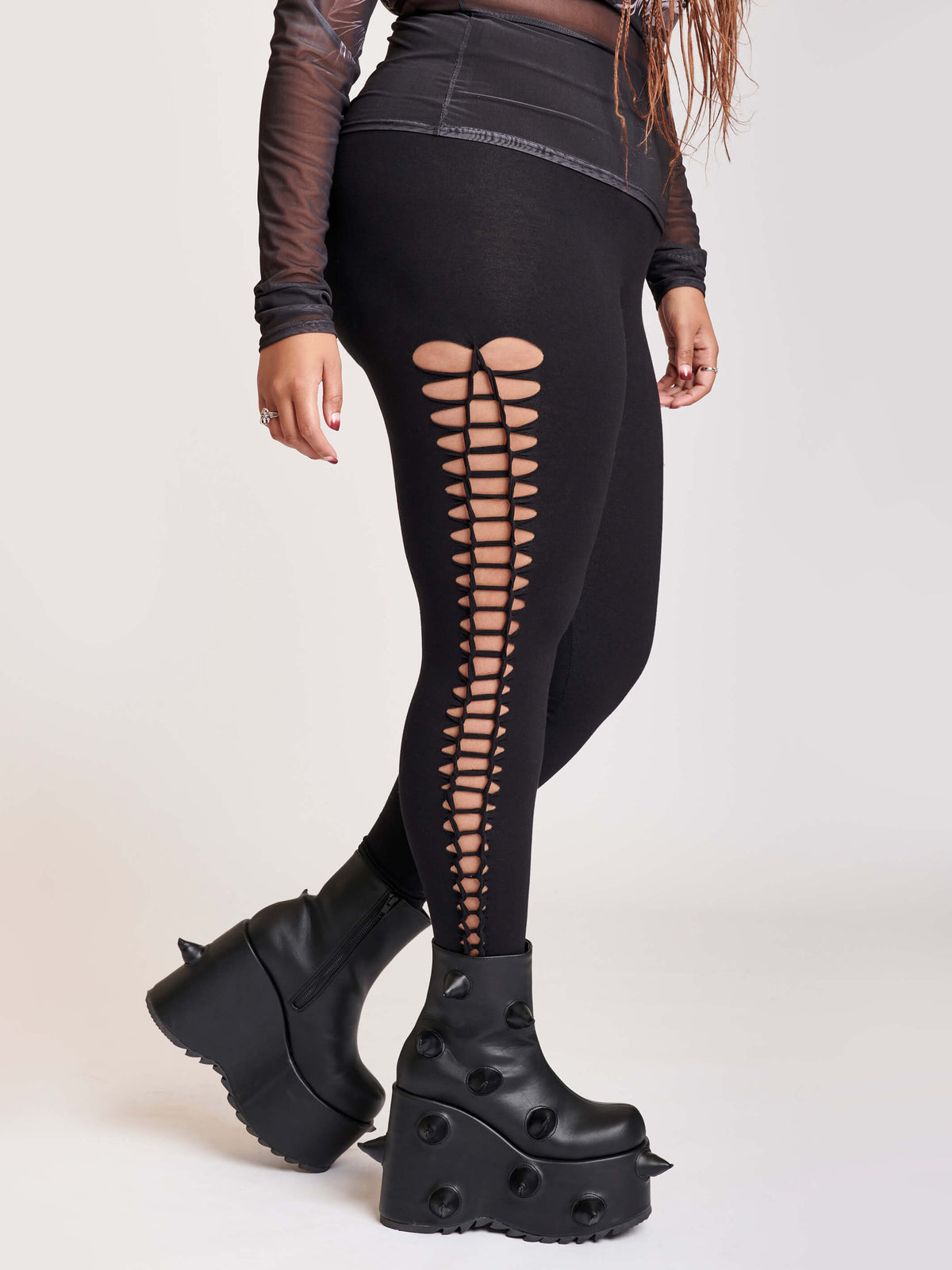 Stretchy cotton spandex leggings with slashed and braided side details.
