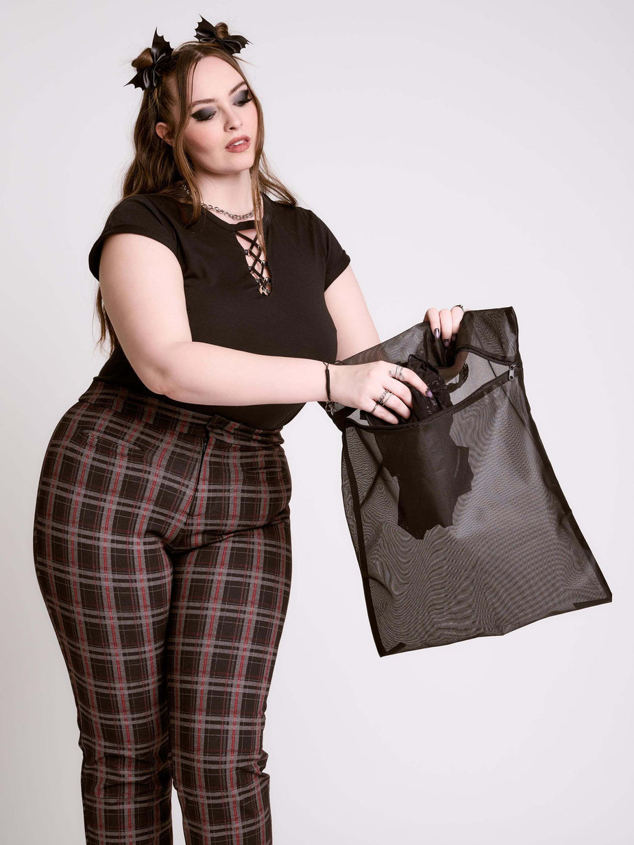 a woman holding a mesh bag