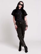 Armory Cropped Shirt is a boxy, cropped, short-sleeve button-down that mixes crisp classic shirting with dark, gothic illustration. 