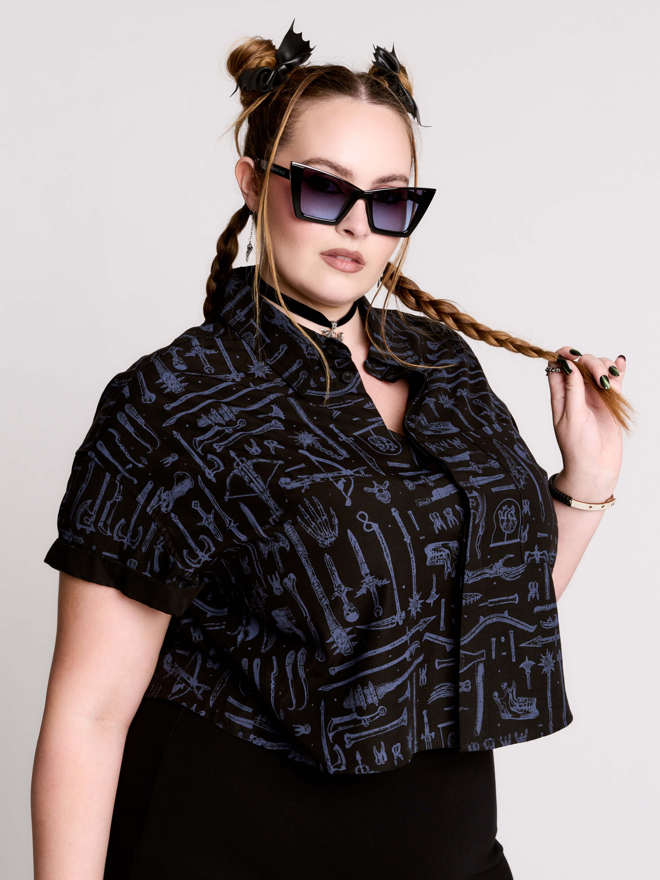Armory Cropped Shirt is a boxy, cropped, short-sleeve button-down that mixes crisp classic shirting with dark, gothic illustration. 