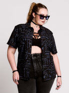 short-sleeve button-down that mixes crisp classic shirting with dark, gothic illustration. 