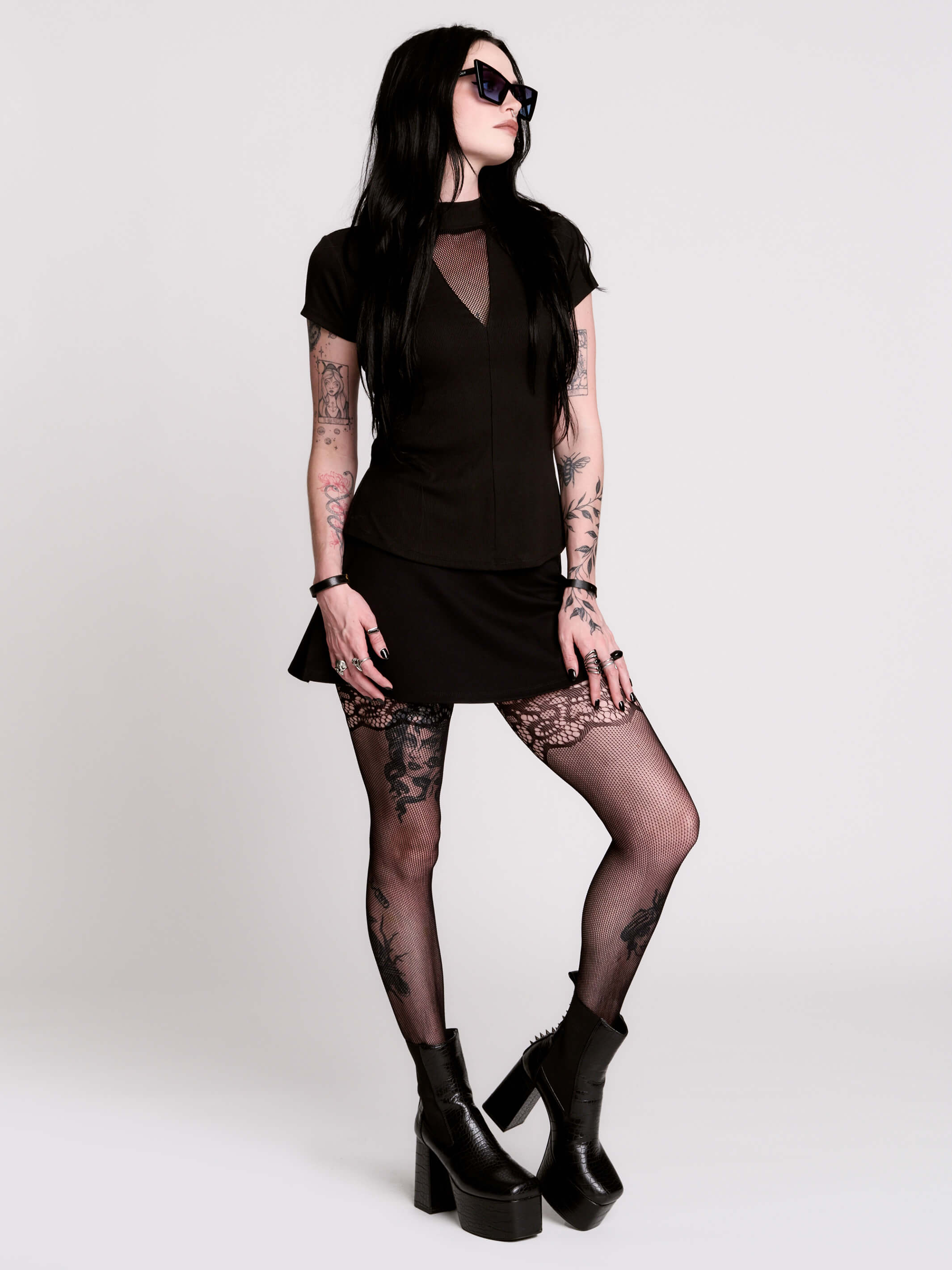 A black short-sleeve mock neck top with a fishnet mesh chest panel.