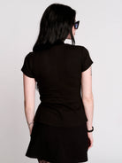 A black short-sleeve mock neck top with a fishnet mesh chest panel.