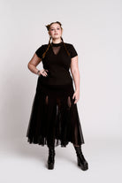 A black short-sleeve mock neck top with a fishnet mesh chest panel.