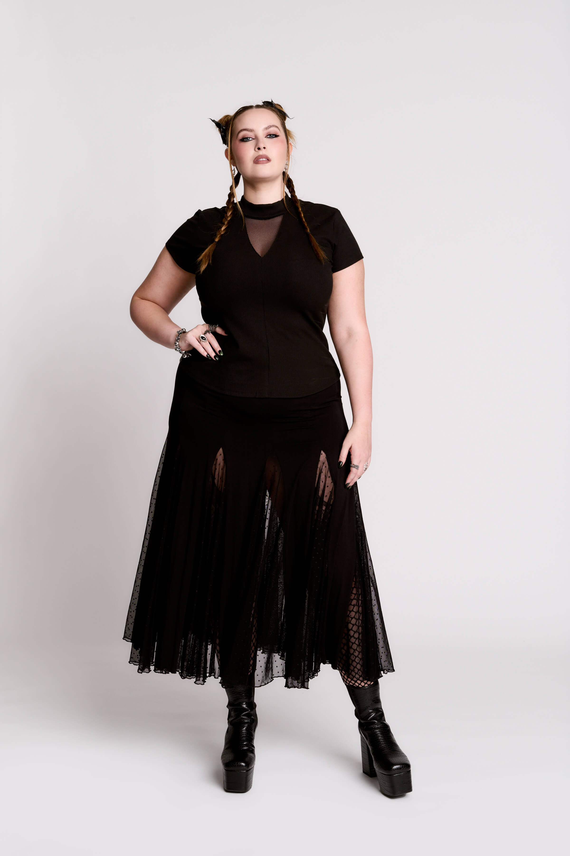 A black short-sleeve mock neck top with a fishnet mesh chest panel.