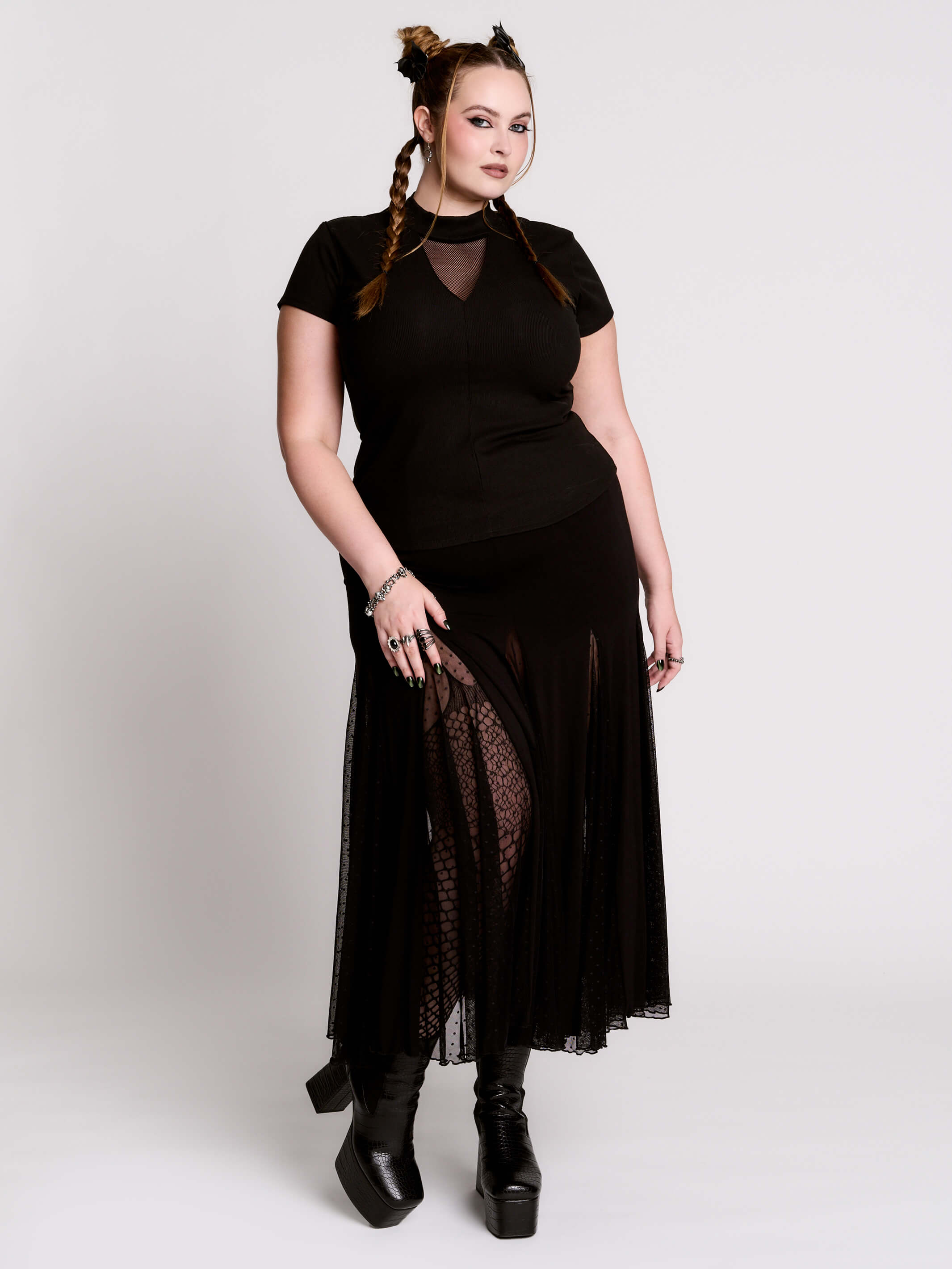A black short-sleeve mock neck top with a fishnet mesh chest panel.