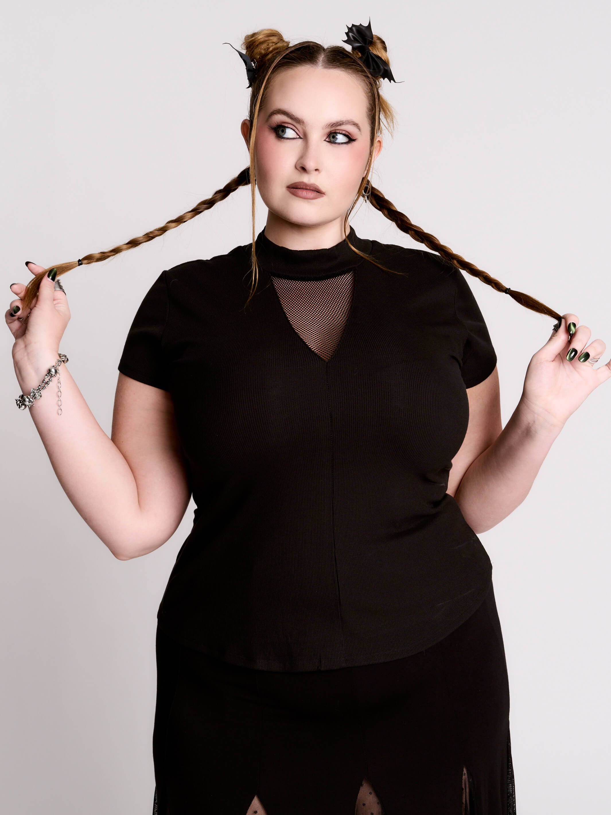 A black short-sleeve mock neck top with a fishnet mesh chest panel.