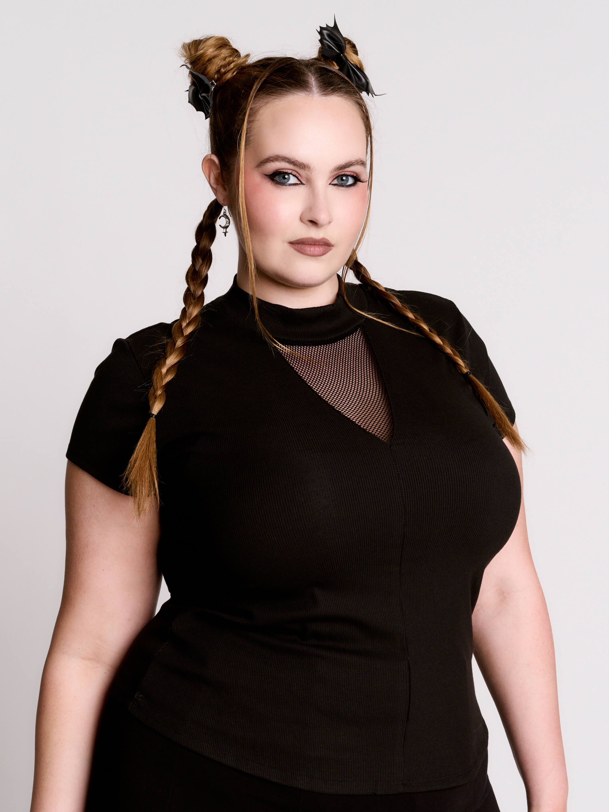 A black short-sleeve mock neck top with a fishnet mesh chest panel.