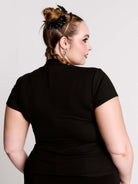 A black short-sleeve mock neck top with a fishnet mesh chest panel.
