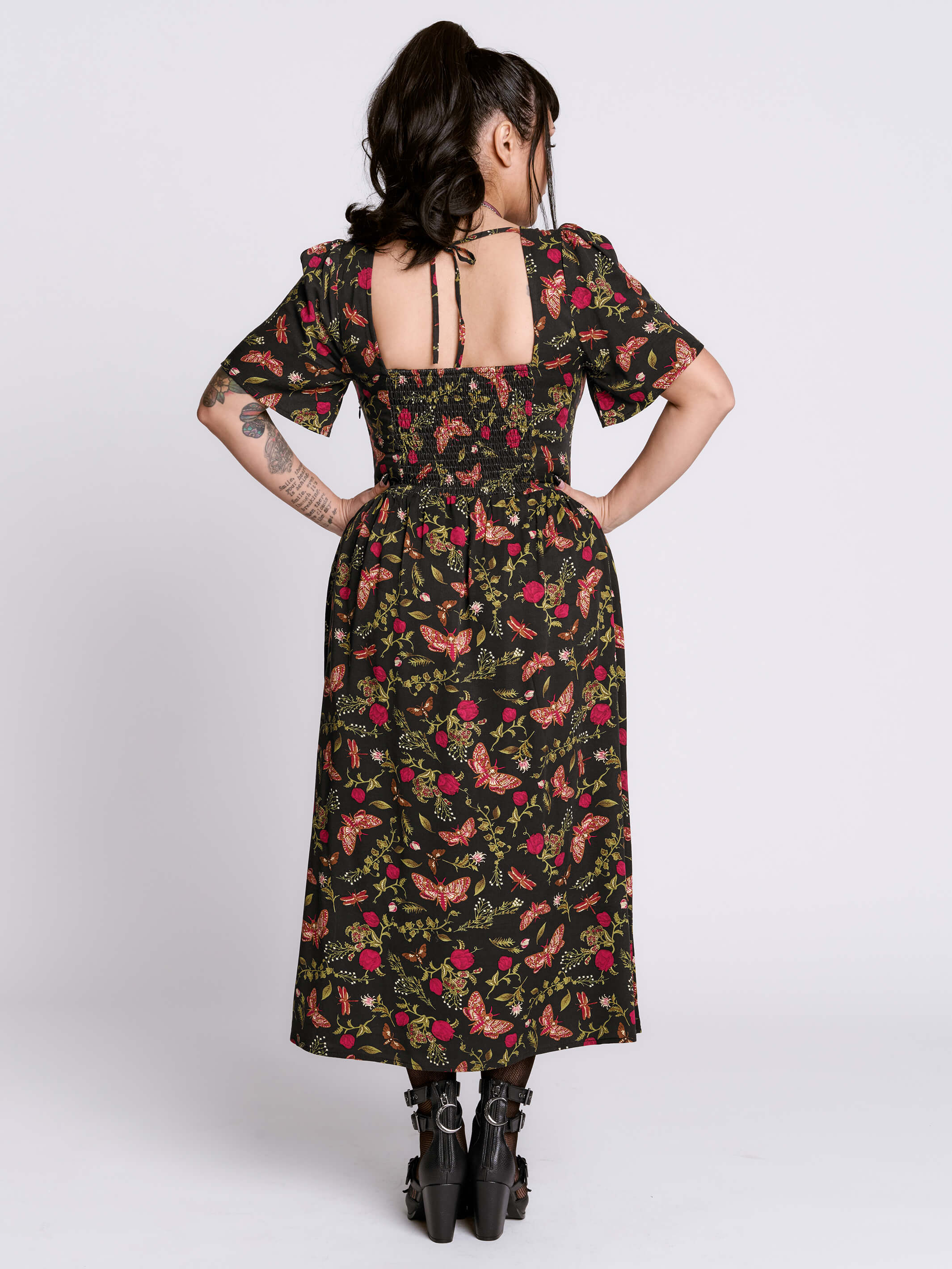 Woman wearing a floral dress with a white background