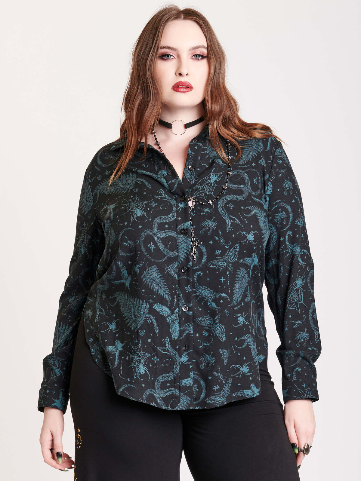 Long sleeve button up top with black and green all over print