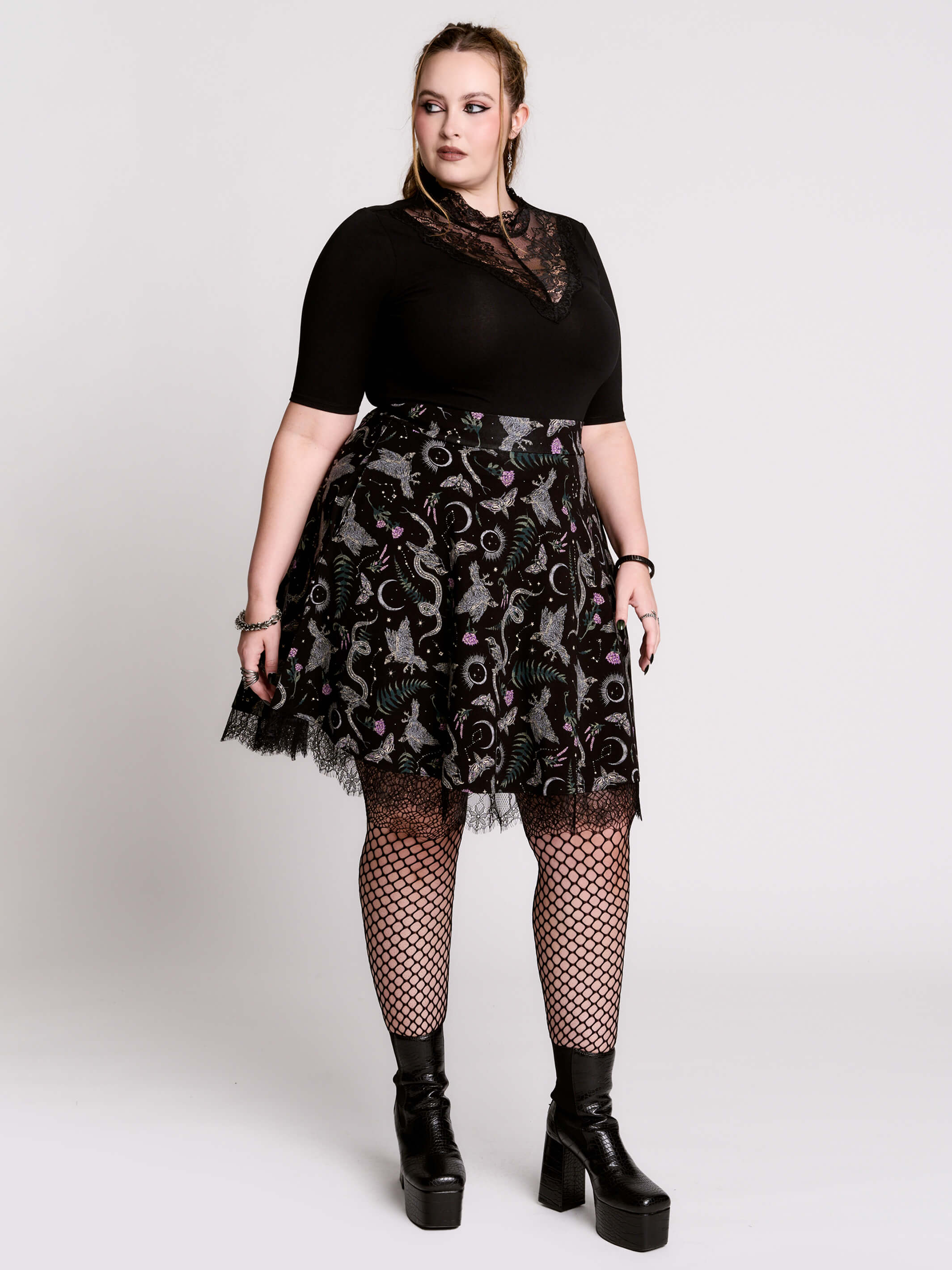 A  black flared skirt featuring a gray and purple gothic print with lace hem.