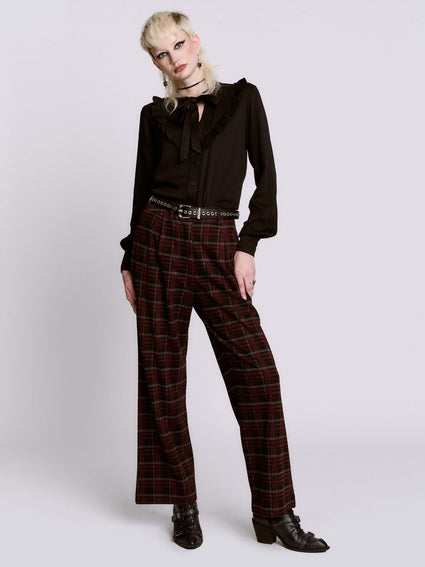 a woman in black shirt and red plaid pants