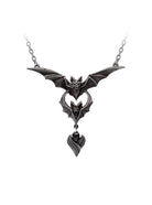 A gothic-style bat pendant necklace with a matching chain, featuring a bat motif with wings spread and a dangling heart-shaped charm, shown on a plain white background.