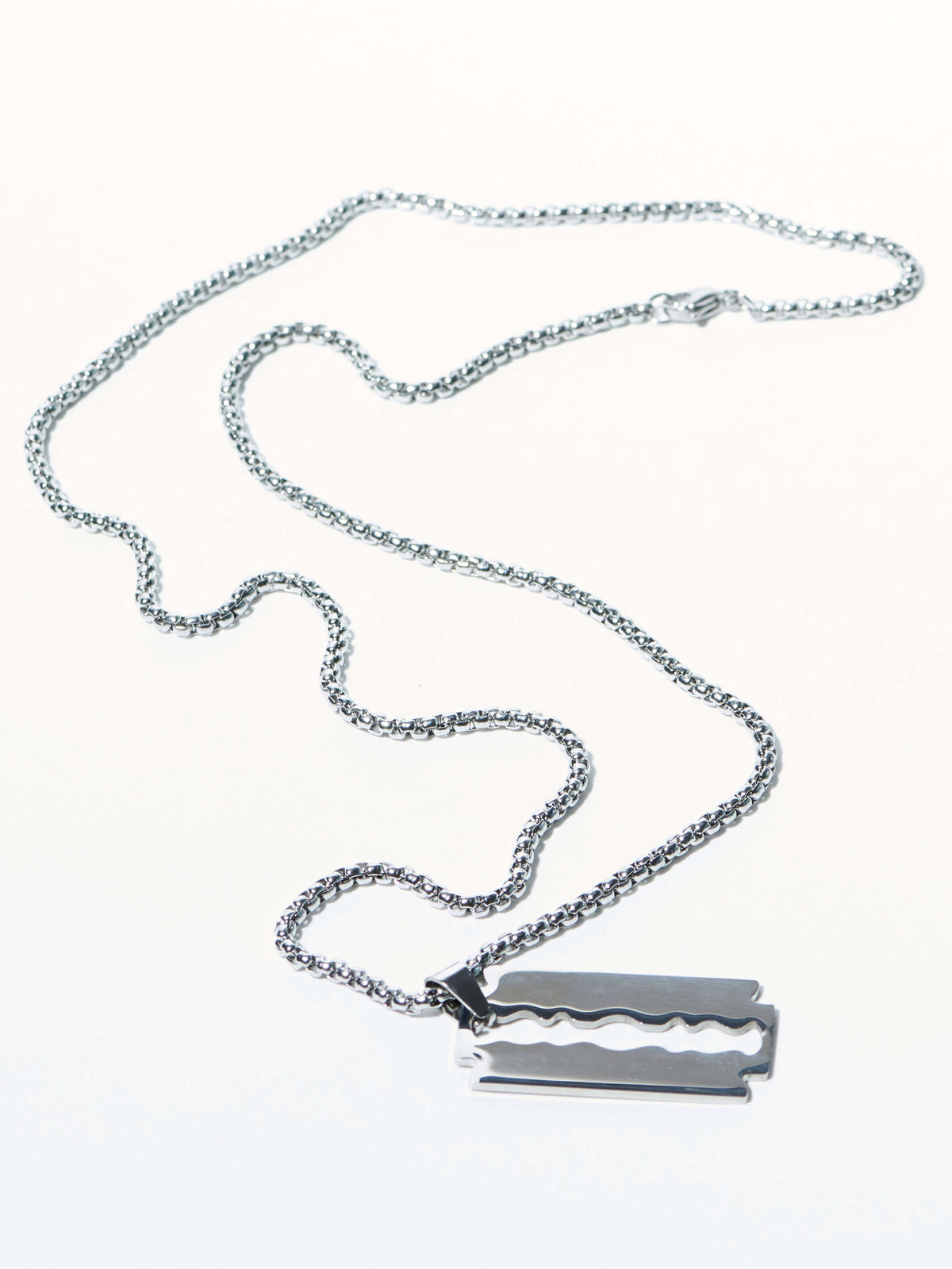 silver toned straight razor on a chain