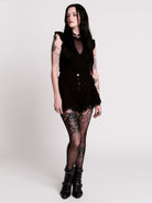 A black ruffled sleeveless top with a sheer chest cutout.