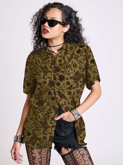 a woman wearing sunglasses and a green shirt