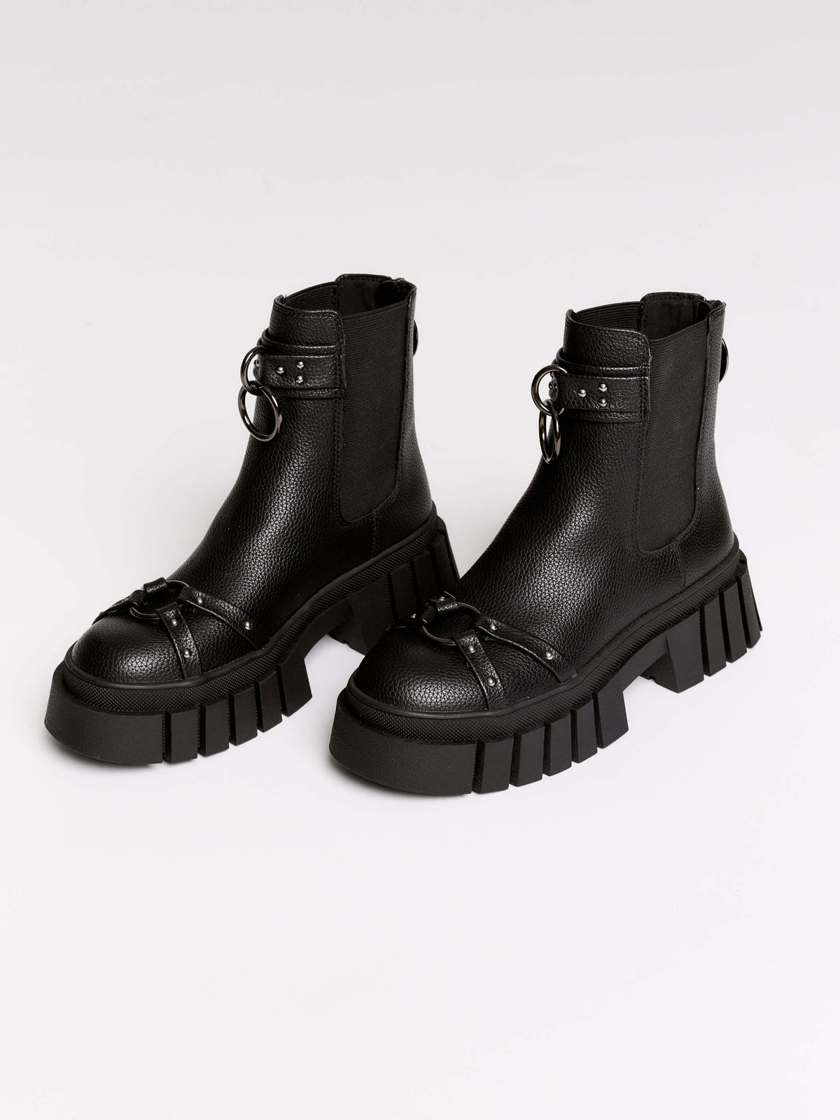 Black chunky platform ankle boots with buckle straps.