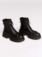 Black chunky platform ankle boots with buckle straps.