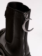 Black chunky platform ankle boots with buckle straps.