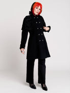 a black double-breasted coat with silver buttons and gothic dragon embroidery on the shoulder cape