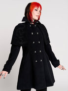 a black double-breasted coat with silver buttons and gothic dragon embroidery on the shoulder cape
