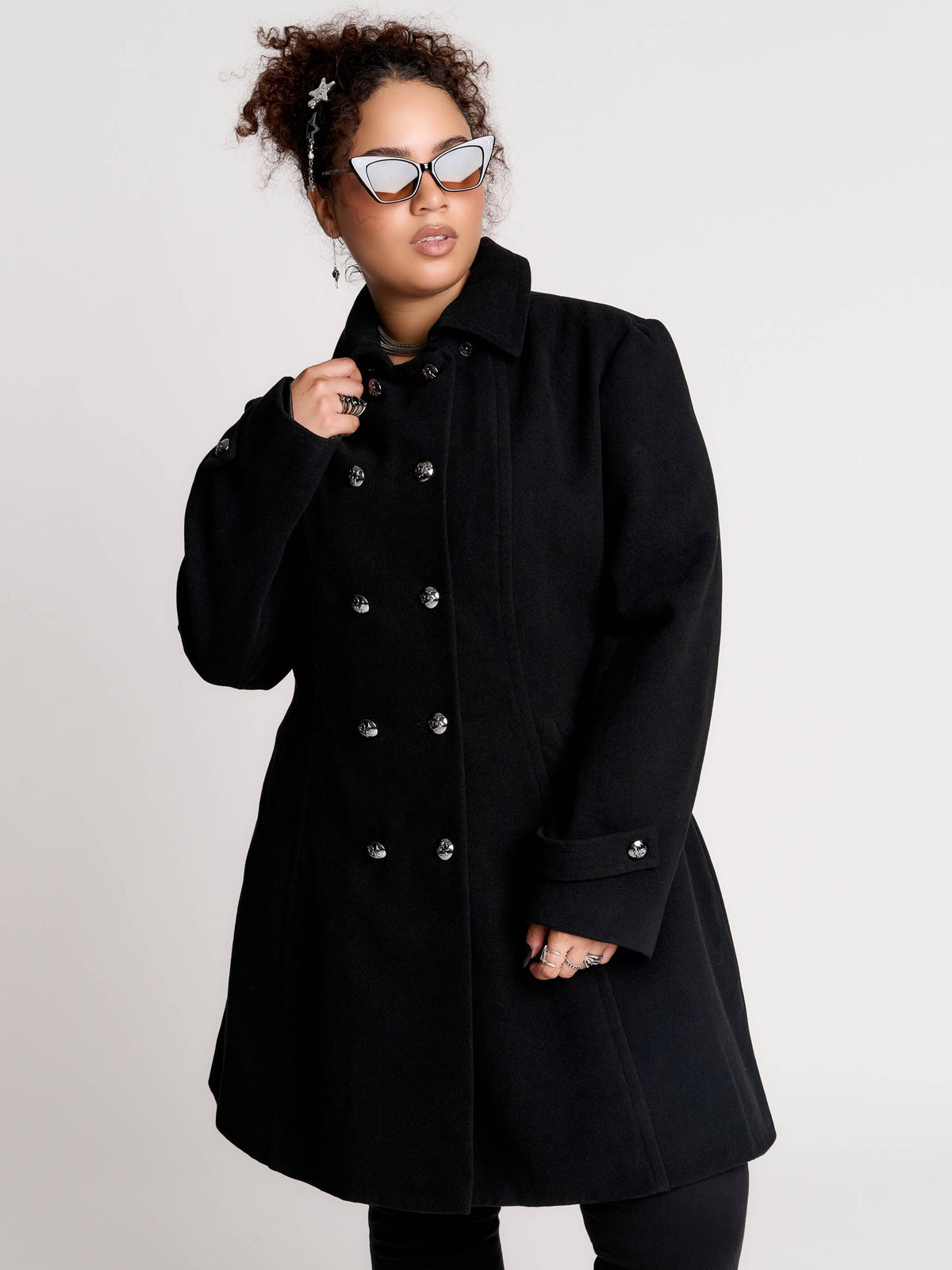 a black double-breasted coat with silver buttons