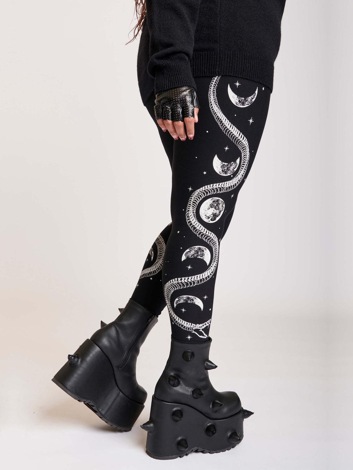 Black legging with skeleton snake and moon phase graphibs down the sides.