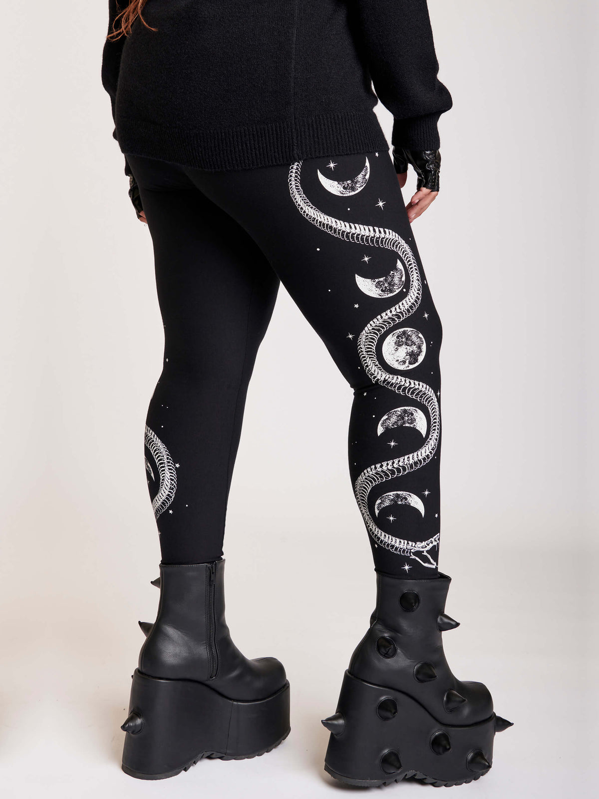 Black legging with skeleton snake and moon phase graphibs down the sides. 